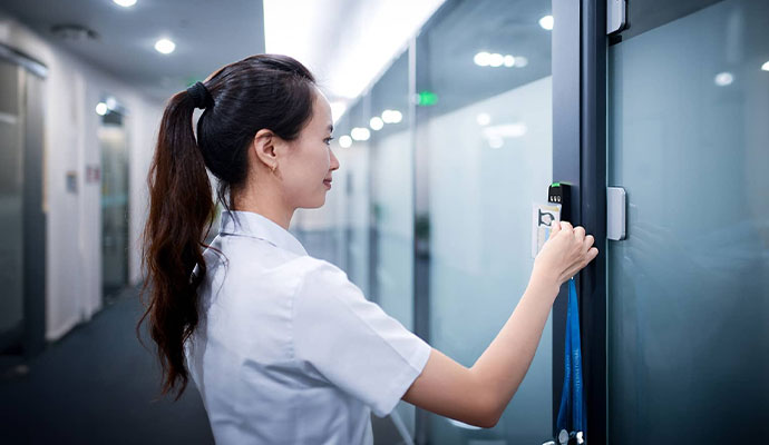 A woman scans an access badge.