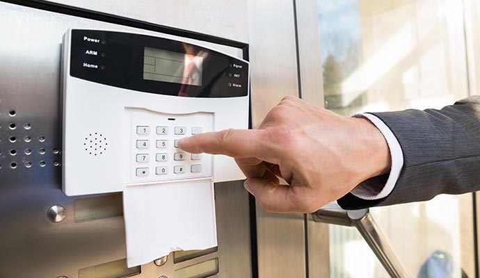 A person operating alarm system guard device