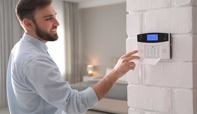 A person using alarm system device