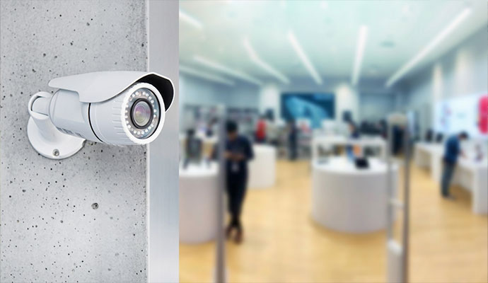 Wall-mounted bullet IP security camera monitoring a commercial store entrance