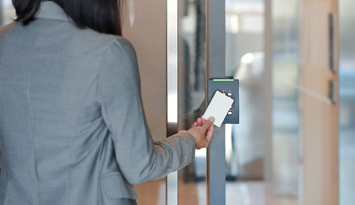 A person using keycard access control system to enter a commercial building