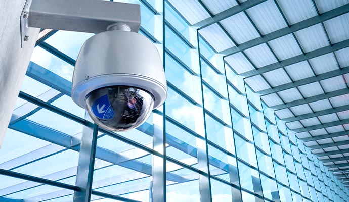 Dome security camera overlooking glass building