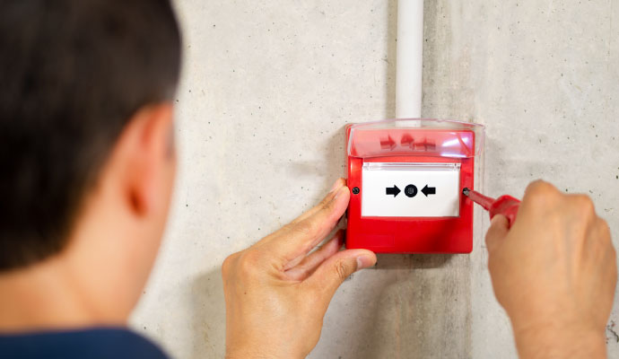 An expert installing fire alarm system