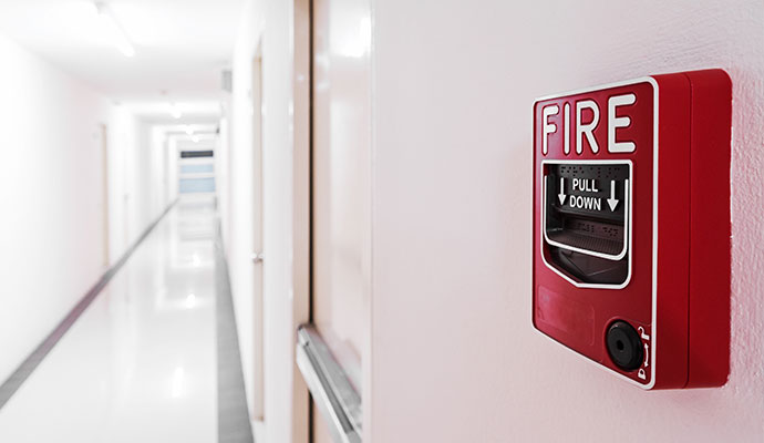 Red fire alarm pull station on the wall