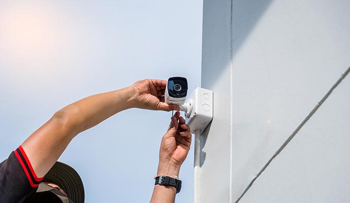 technician installing outdoor camera