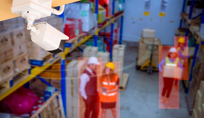 AI video deterrence camera tracking warehouse workers with detection overlays