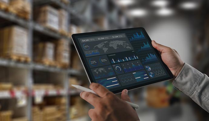 Person viewing warehouse analytics dashboard with charts on a tablet