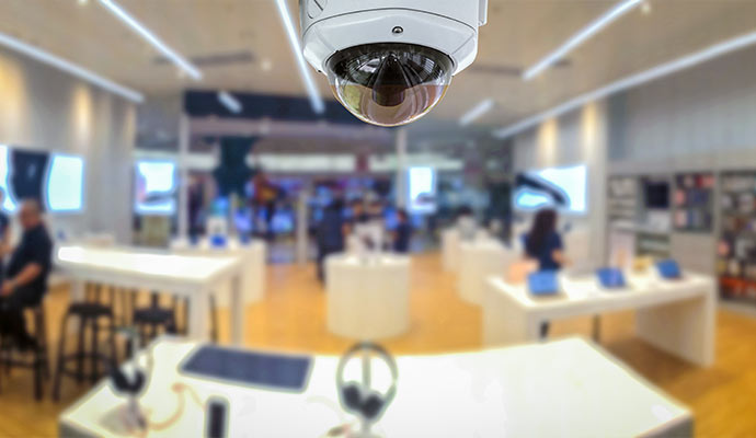 White dome camera monitoring electronics store